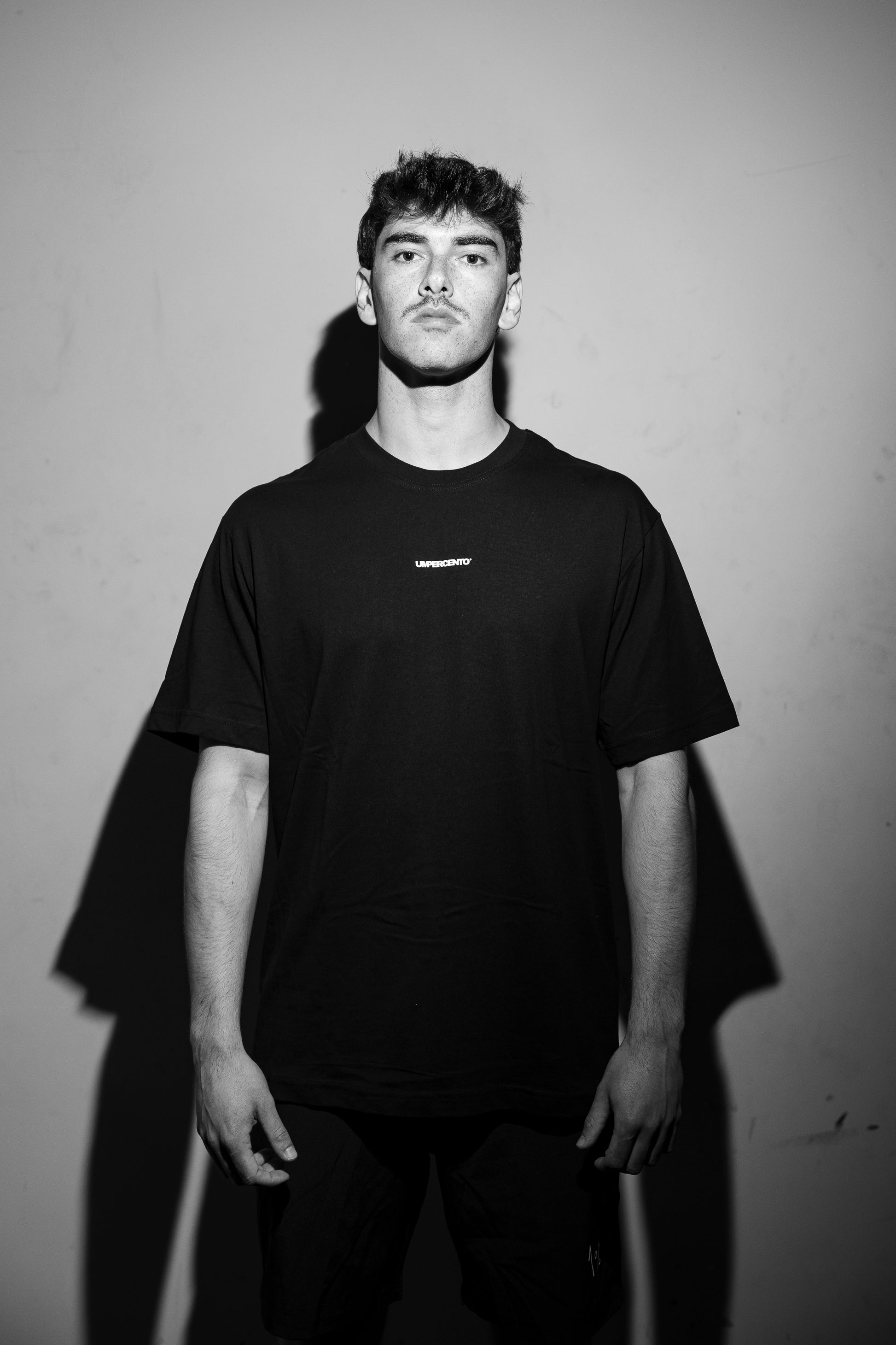 Model wearing oversized black T-shirt — front view, relaxed fit