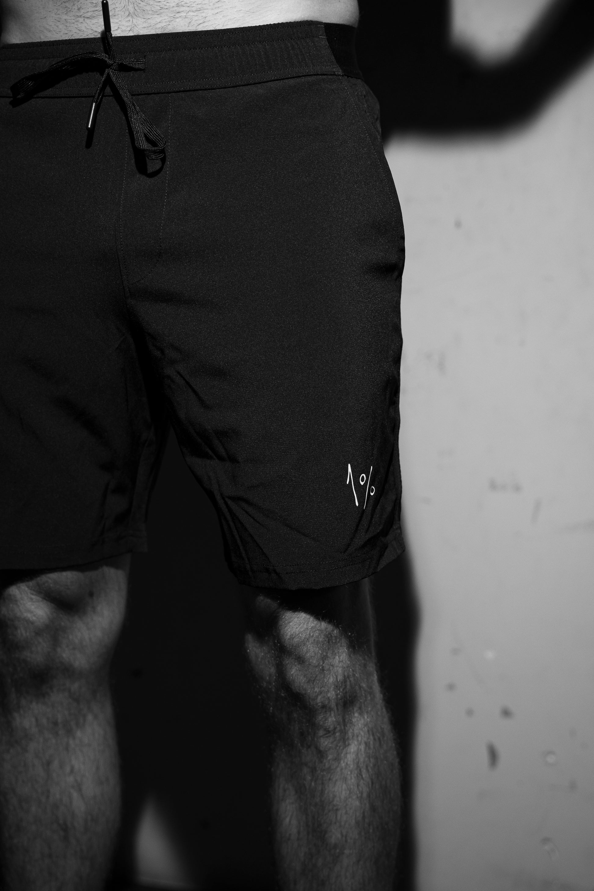 Front view of men’s performance shorts on model — training ready